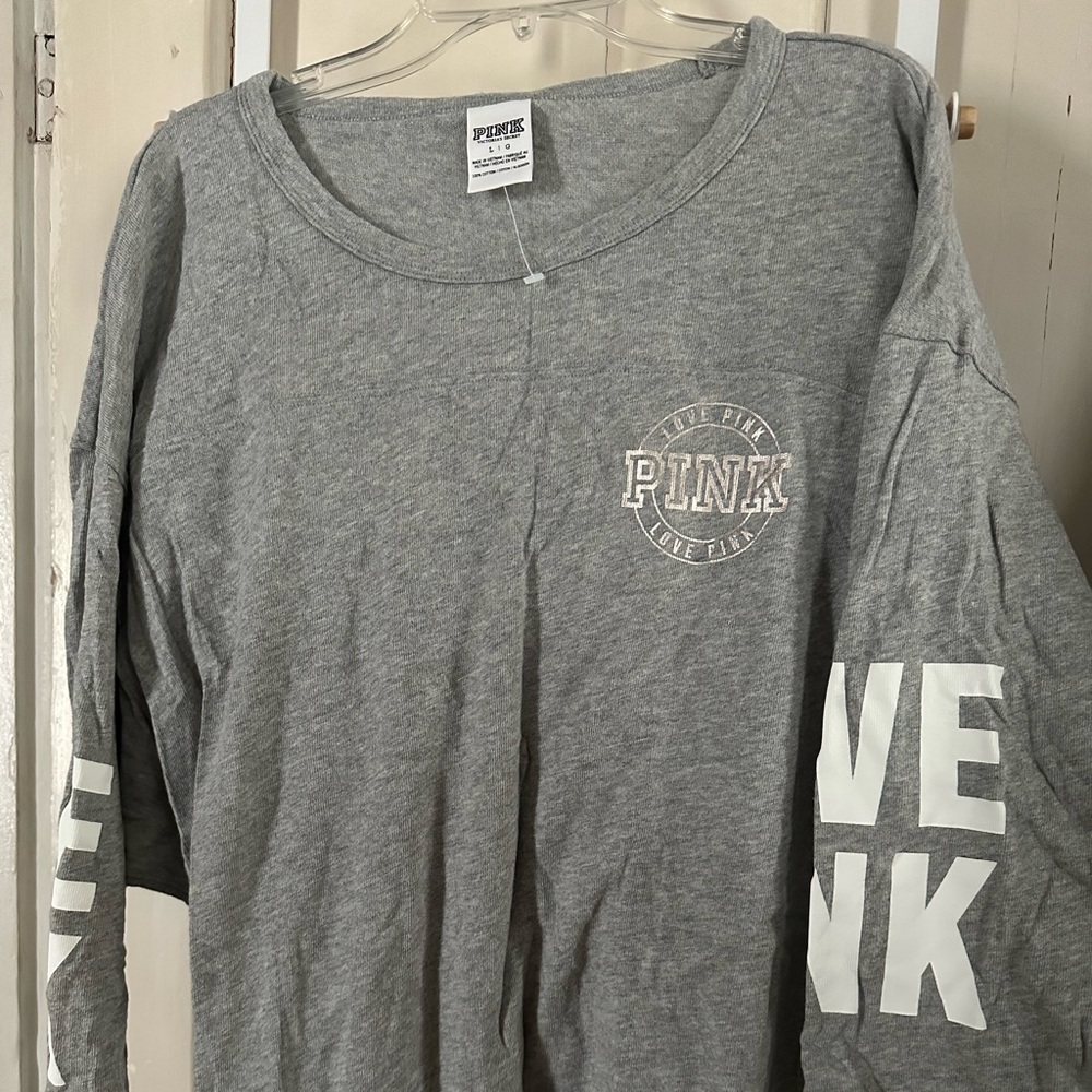 Pink 3/4 sleeve shirt. Super soft never worn. Curved bottom